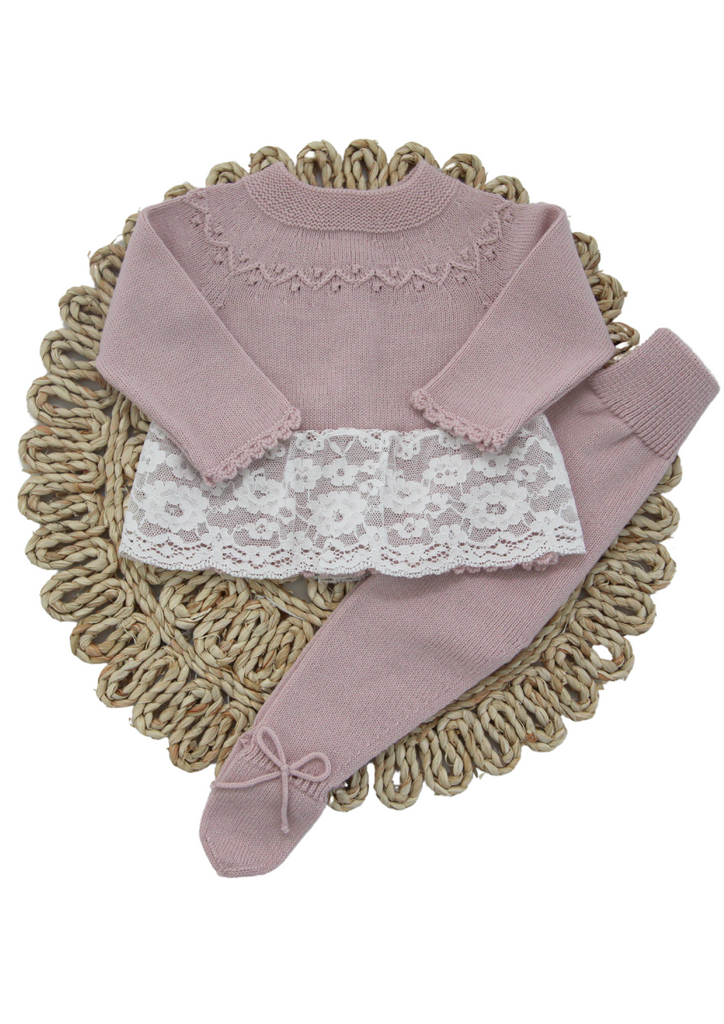 Ivory, light pink and old rose knitted two-piece set for newborn girls by Artesania Granlei. This delicate and elegant babysuit has scalloped trims and a beautiful lace overlay on the hem. The matching pants have and little knitted bows on the feet. Made in Spain